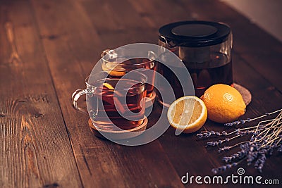 Two full Cup of black tea with lemon and teapot Stock Photo