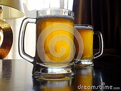 Two full glasses of craft beer on the table at pub desk Stock Photo