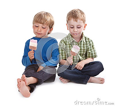 Two funny boys eating ice lolly Stock Photo