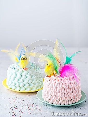 Two Funny cakes pink and pink with easter topper for kids with easter decorations on light background with space fot text. Easy Stock Photo