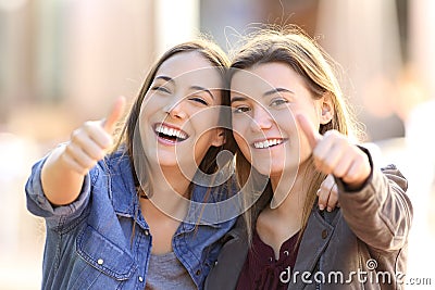 Two funny friends with thumbs up Stock Photo