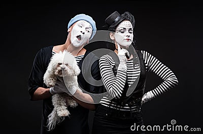 Two funny mimes holding red heart Stock Photo