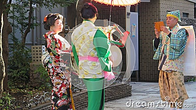 Two geishas posing for photo in Tokyo street Editorial Stock Photo