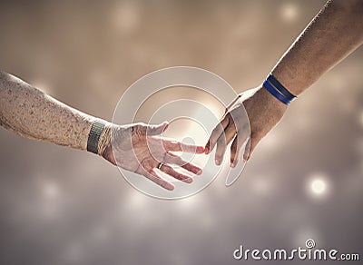 Two generations connecting. Two human hands touching. And old woman and a young diverse man Stock Photo