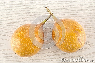 Fresh Raw Grenadilla passionfruit on grey wood Stock Photo