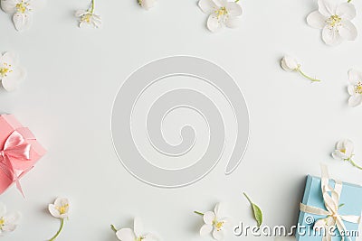 Two gifts surrounded by Apple white flowers. blue and pink presents. pretty background Stock Photo