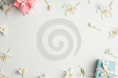 Two gifts surrounded by Apple white flowers. blue and pink presents. Stock Photo