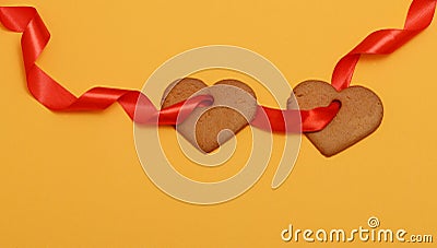 Two gingerbread hearts strung on a red ribbon Stock Photo