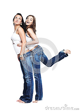 Two girlfriends in blue jeans isolated on white Stock Photo