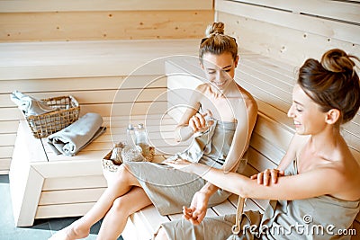 Two girlfriends relaxing in the sauna Stock Photo