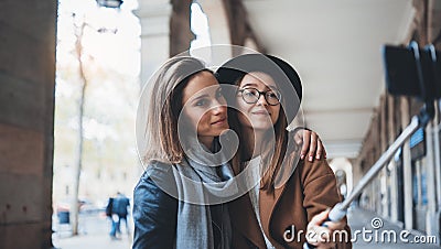 Two girlfriends taking photo selfie on smartphone mobile in city. Blogger hipster travels in Barcelona. Holiday friendship concept Stock Photo