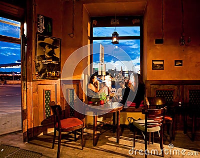 Two girls chating and sit on the window of art cafe Editorial Stock Photo