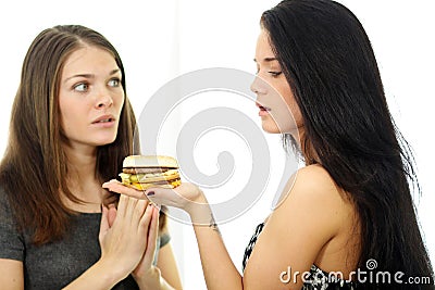 Two girls divide one sandwich Stock Photo