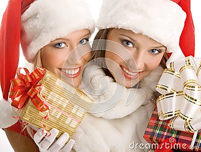 Two Girls Dressed as Santa Claus Happily Hold Boxes With Gifts Stock Photo