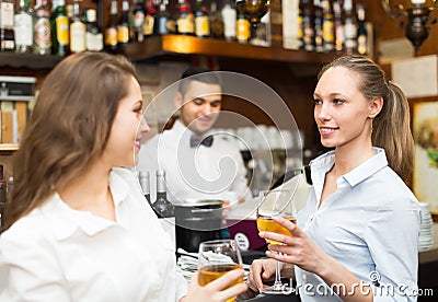 Two girls flirting with barman Stock Photo