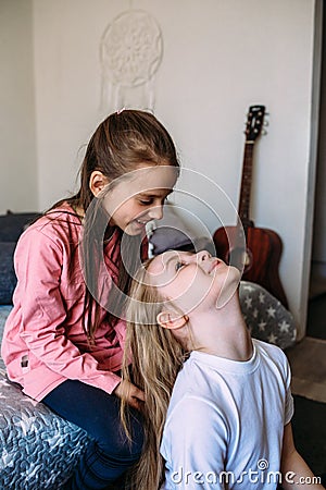 Two girls friends play at home after school, have fun Stock Photo