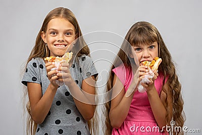 Two girls are funny eating bread Stock Photo