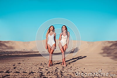 Two girls girlfriends body bathing suits, sunbathe summer city. Walking along beach, tourist. Rest sea, style and Stock Photo
