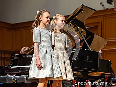 Two girls going to play four hands concert. Editorial Stock Photo