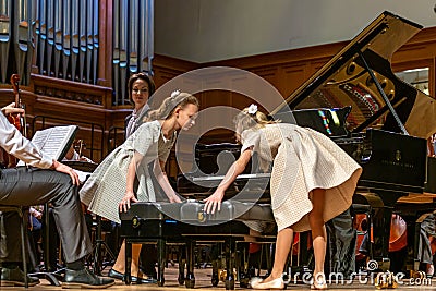 Two girls going to play four hands concert. Editorial Stock Photo