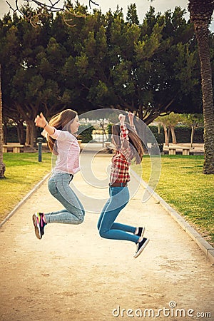 Two girls have fun in park Stock Photo