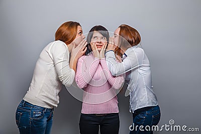 Two girls in jeans European appearance whisper Stock Photo