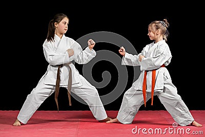 Two girls in kimono are training paired exercises karate Stock Photo