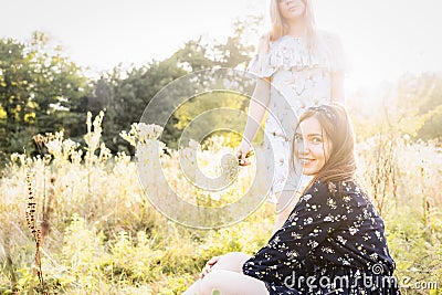 Two girls on nature in high grass Stock Photo