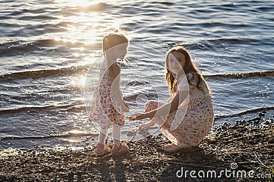 Two girls play on the shore Stock Photo