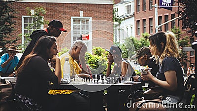 Two girls playing chess at a park Editorial Stock Photo