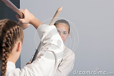 Two girls practice sword on Aikido training Stock Photo