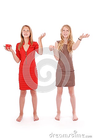 Two girls pretend that juggle fruit Stock Photo