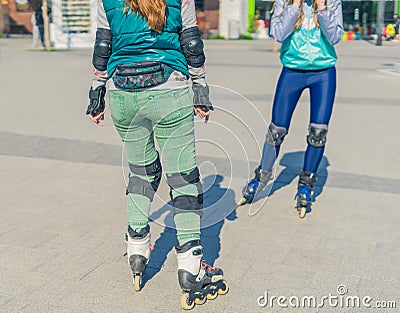 Two girls rollers meet each other in the park Stock Photo