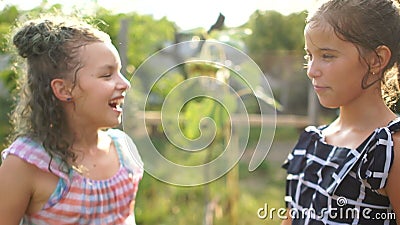 Two girls schoolgirls girlfriend jumping in spray of water. Summer holidays, good mood, happy children stock footage Two girls schoolgirls girlfriend jumping in spray of water. Summer holidays, good mood, happy children stock footage