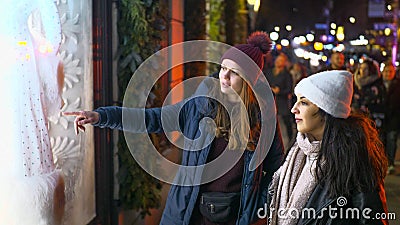 Two girls on a shopping trip in New York walk along shop windows - NEW YORK, USA - DECEMBER 4, 2018 Editorial Stock Photo