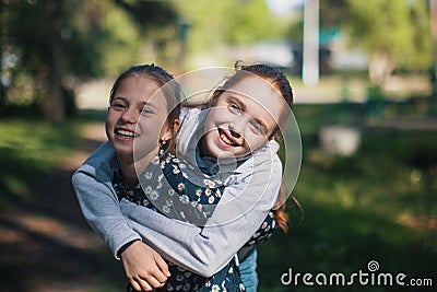 Two girls sisters or girlfriends having fun outdoors. Stock Photo