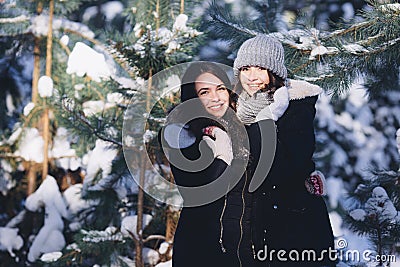 Two girls in a snowy forest Stock Photo