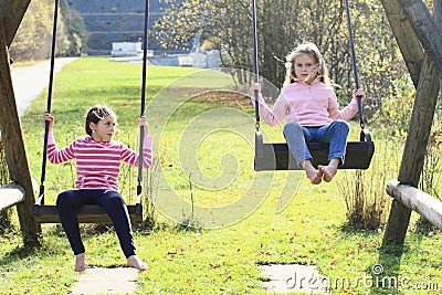 Two Girls Swinging On Two Swings Royalty Free Stock Photography - Image ...