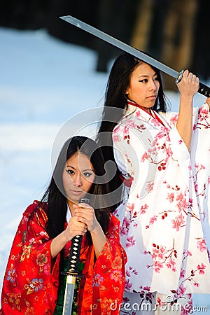 Two girls about a sword in hands Stock Photo