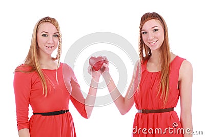 Two girls twins in red dresses with gift Stock Photo