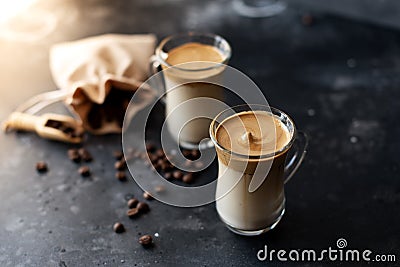 Two glass cups with Dalgona frothy coffee trend korean drink latte espresso with coffee foam on black background Stock Photo