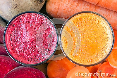 Two glass of fresh beet and carrot juice, beetroot and carrots vegetable, top view. Stock Photo