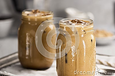 Two Glass Jars Filled With Iced Coffee with Cream Stock Photo