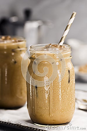 Two Glass Jars with Iced Coffee with Milk Stock Photo