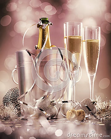 Two glasses of champagne with bottle in cooler on a pink background, selective focus Stock Photo