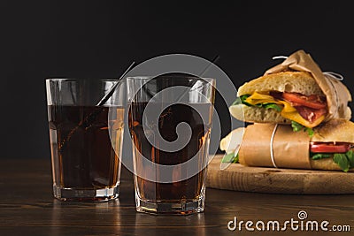 Two glasses of cola on table and panini Stock Photo