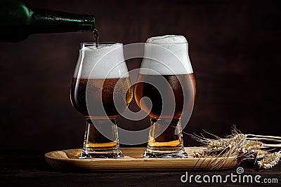 Two glasses of cold golden beer and wheat spikelets Stock Photo