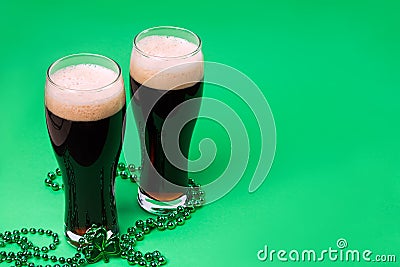 Two glasses of dark stout beer and traditional clover shaped decor Stock Photo