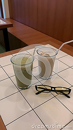 two glasses of drink in an aesthetic coffee shop Stock Photo