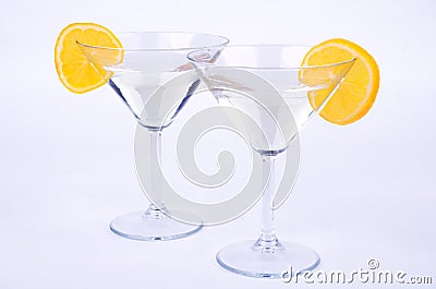 Two glasses of martini and lemon on blue Stock Photo